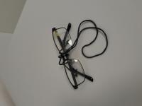 BLACK EYEGLASSES WITH BLACK CORD AND YELLOW STICKER